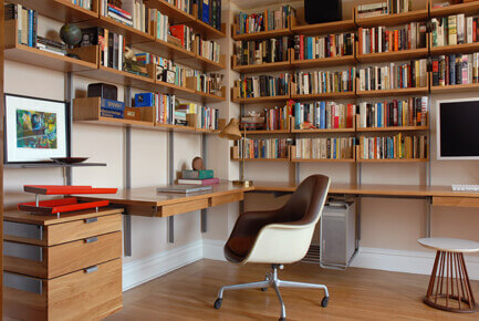 Home office with desk, pencil drawers, storage drawers, racks and bookshelves.